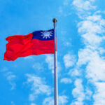 Taiwanese flag raised blowing in the wind with blue sky